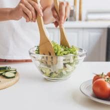 Cropped shot of woman preparing delicious healthy salad